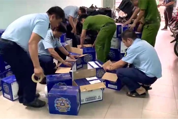 Lực lượng chức năng đang kiểm tra kiểm đếm số lượng rượu bị phát hiện, tạm giữ.
