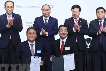 Chủ tịch nước Nguyễn Xuân Phúc và Phó Thủ tướng Hàn Quốc Choo Kyung Ho chứng kiến lễ trao biên bản hợp tác giữa các doanh nghiệp hai nước. (Ảnh: Thống Nhất/TTXVN)