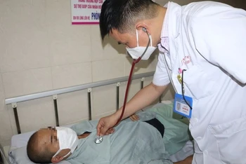 Bác sĩ khám cho bệnh nhân mắc sốt xuất huyết.