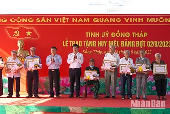 Bí thư Tỉnh ủy Đồng Tháp Lê Quốc Phong trao Huy hiệu Đảng cho các đảng viên. (Ảnh: HỮU NGHĨA)