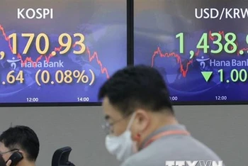 Màn hình hiển thị chỉ số chứng khoán KOSPI (trái) tại ngân hàng Hana ở Seoul, Hàn Quốc. (Ảnh: Yonhap/TTXVN)