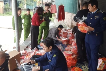 Kiểm tra hộp mứt có dấu hiệu giả mạo nhãn hàng hóa, bao bì. (Ảnh: Quản lý thị trường tỉnh cung cấp)
