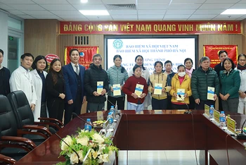 Đại diện lãnh đạo Bảo hiểm xã hội Hà Nội trao hỗ trợ các bệnh nhân có thẻ bảo hiểm y tế. Ảnh: HSS