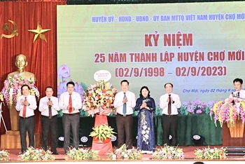 Lãnh đạo tỉnh Bắc Kạn tặng hoa chúc mừng huyện Chợ Mới. (Ảnh: ĐĂNG BÁCH).