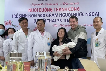 Niềm vui của gia đình chị Dung khi đón cậu con trai bé nhỏ từ tay PGS, TS Trần Danh Cường.