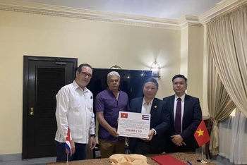 Phó Chủ tịch Ủy ban Nhân dân Thành phố Hồ Chí Minh Dương Anh Đức chuyển số tiền 250.000 USD cho đồng chí Raul Rodriguez Carricate, Vụ trưởng Vụ Hợp tác Quốc tế, Bộ Ngoại thương và Đầu tư Cuba.