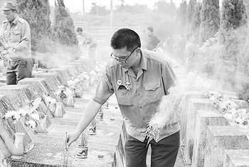 Cựu chiến binh Nguyễn Đình Thắng thắp hương cho đồng đội cũ ở Nghĩa trang Vị Xuyên.