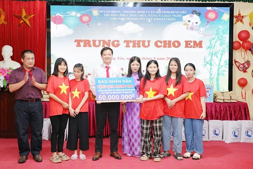 Đại diện Báo Nhân Dân và Công ty cổ phần Văn hóa Đọc và Học Việt Nam tặng quà cho nhà trường.