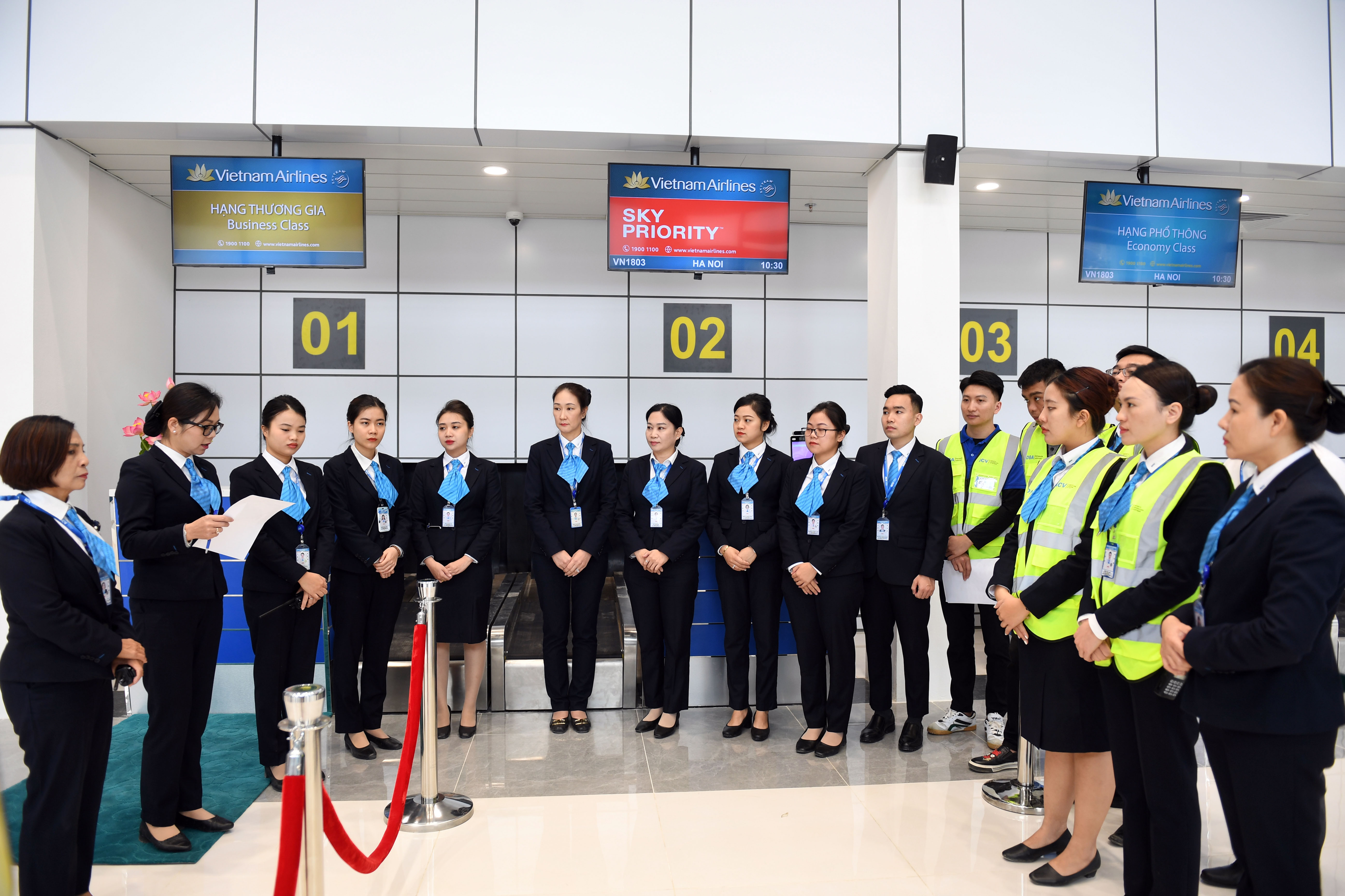 Các nhân viên phục vụ mặt đất họp trao đổi nhanh công tác chuẩn bị quầy làm thủ tục theo kế hoạch chuyến bay.