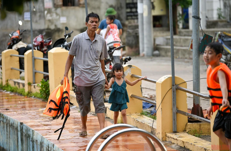 Ao làng nước màu xanh lục thủy ' biến' thành bể bơi cho trẻ em -0