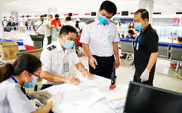 Lực lượng chức năng tại sân bay Tân Sơn Nhất (TP Hồ Chí Minh) tăng cường kiểm tra, cách ly người về từ các vùng dịch Covid-19. Ảnh: ĐỘC LẬP