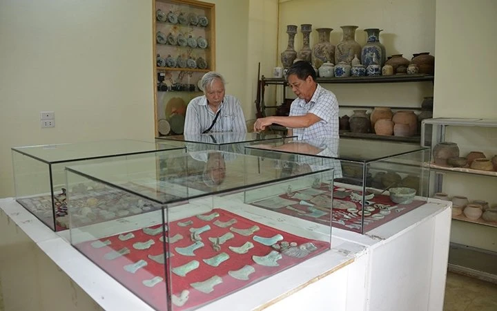 Ông Phạm Văn Hùng trao đổi với Giáo sư Nguyễn Văn Huy về các hiện vật sưu tầm được ở Vườn Chuối.