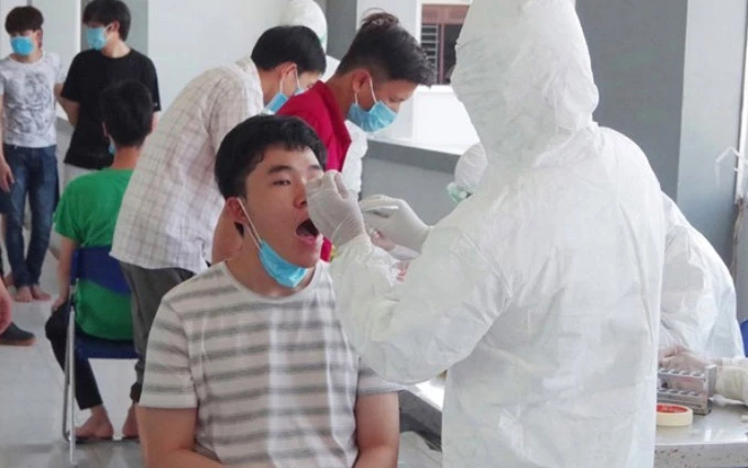 Nhân viên y tế Quảng Nam lấy mẫu xét nghiệm công dân Việt Nam về từ Nhật Bản.