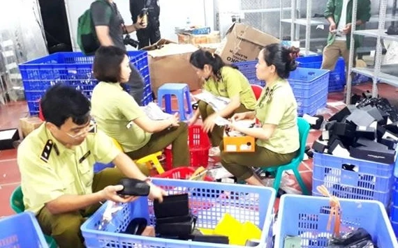Lực lượng chức năng kiểm tra và thu giữ các mặt hàng nhập lậu, tại kho hàng 145, đường Hoàng Diệu, phường Lào Cai, thành phố Lào Cai.