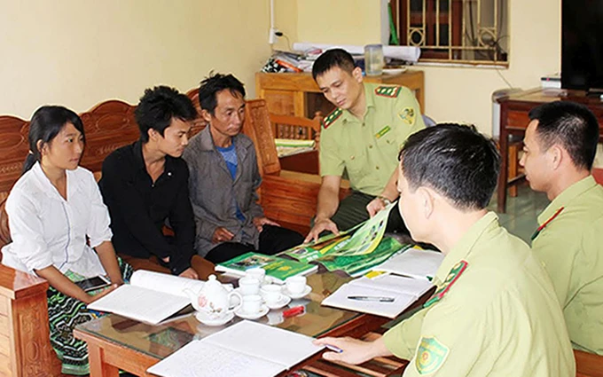 Cán bộ kiểm lâm huyện Trấn Yên (Yên Bái) tuyên truyền, hướng dẫn người dân cam kết bảo vệ rừng, phòng cháy, chữa cháy rừng.