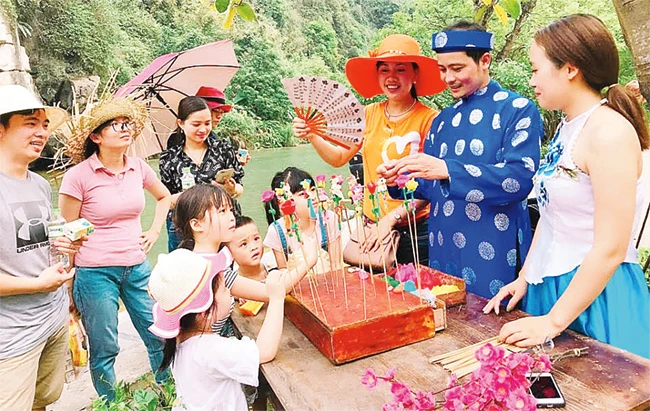 Nghệ nhân Nguyễn Văn Thành hướng dẫn các em nhỏ nặn tò he.