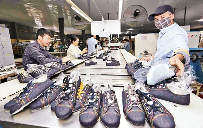 Sản xuất giày xuất khẩu tại Công ty TNHH Hóa dệt Hà Tây, huyện Đan Phượng. Ảnh: TRẦN VIỆT