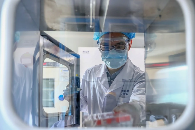 Một nhân viên lấy mẫu vaccine bất hoạt Covid-19 tại một nhà máy sản xuất vaccine của Tập đoàn Dược phẩm Quốc gia Trung Quốc (Sinopharm) ở Bắc Kinh, Trung Quốc, ngày 11-4. Ảnh: Tân Hoa xã.
