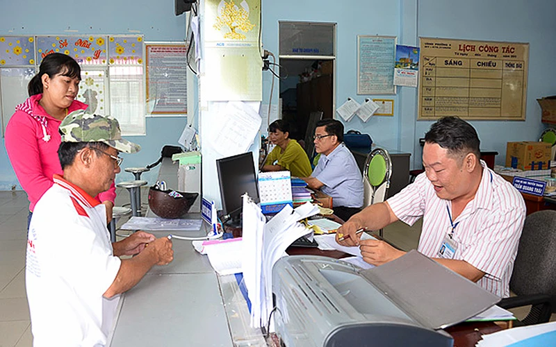 Người dân thực hiện thủ tục hành chính tại UBND phường 8 (TP Sóc Trăng, tỉnh Sóc Trăng). Ảnh: M. LINH 