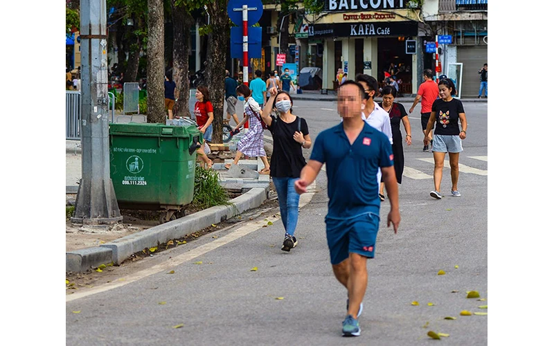 Nhiều người dân tại Hà Nội vẫn chưa đeo khẩu trang ở nơi công cộng theo quy định. Ảnh: HƯNG BÙI