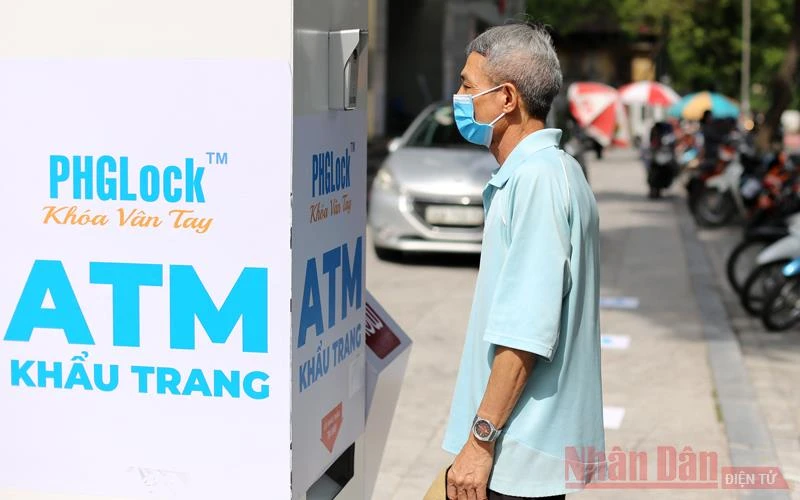 Người dân Hà Nội nhận khẩu trang y tế miễn phí từ "cây ATM khẩu trang".