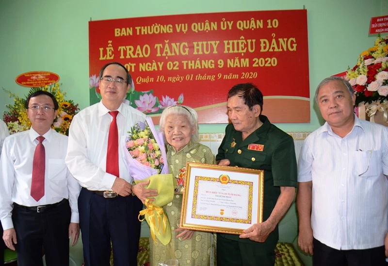 Đồng chí Nguyễn Thiện Nhân trao Huy hiệu 75 năm tuổi Đảng cho đồng chí Trần Thị Phát.