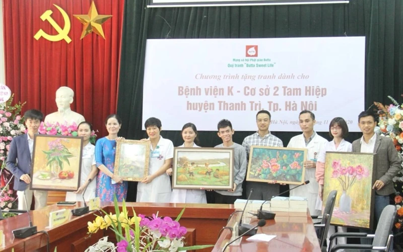 Họa sĩ Nguyễn Thị Kim Đức (thứ ba từ trái sang) trao tặng bộ tranh cho Bệnh viện K cơ sở 2. (Ảnh: Nguyễn Hoàng)