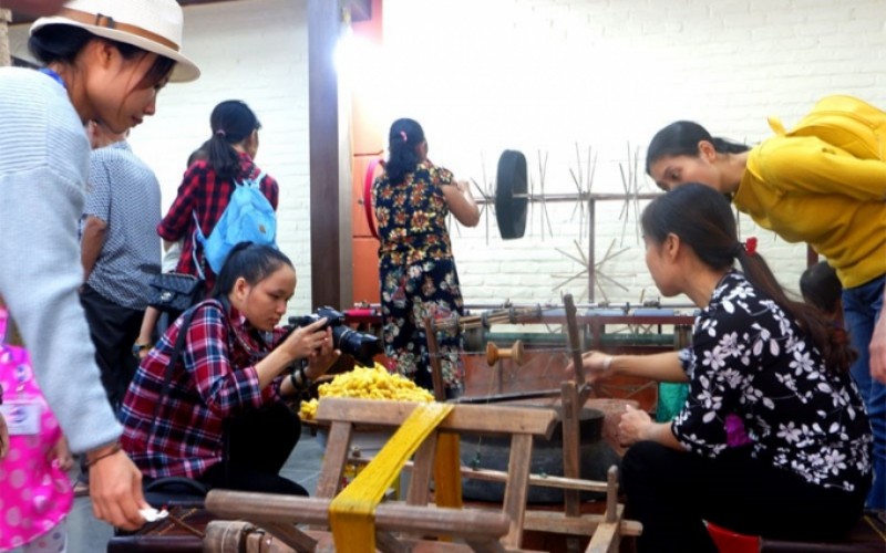 Khách hàng tham quan quy trình sản xuất lụa tơ tằm tại làng Vạn Phúc (quận Hà Đông).