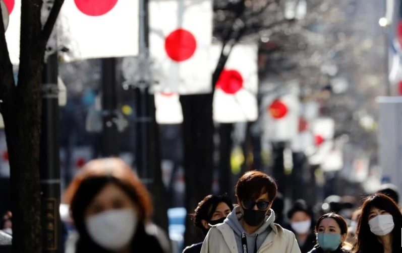 Người Nhật Bản ở Tokyo đi bộ đeo khẩu trang bảo vệ trong bối cảnh dịch Covid-19 bùng phát ngày 10-1. Ảnh: Reuters.
