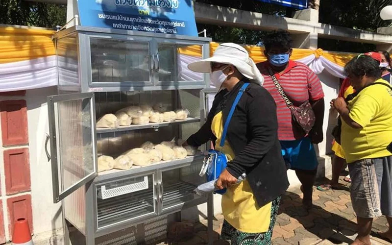 Người dân nhận gạo từ một tủ góp gạo từ thiện tại tỉnh Surat Thani. (Ảnh: Bưu điện Bangkok)