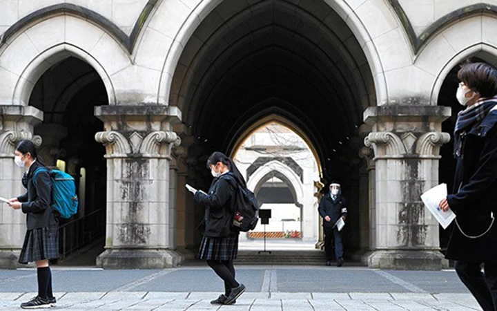 Các thí sinh thi đại học giữ khoảng cách trong khi chờ kiểm tra sơ bộ đầu vào tại Tokyo, Nhật Bản. Ảnh: The Asahi Shimbun