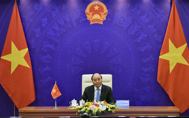 Thủ tướng Nguyễn Xuân Phúc phát biểu tại hội đàm trực tuyến với Thủ tướng Lào Thoong-lun Xi-xu-lít và Thủ tướng Cam-pu-chia Hun Xen. Ảnh: TRẦN HẢI 