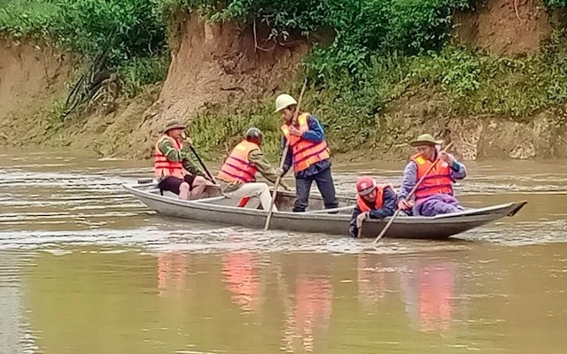 Lực lượng chức năng xã Hương Hóa (Quảng Bình) tìm kiếm thi thể nạn nhân bị lũ cuốn.
