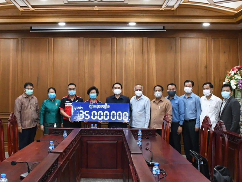 Bí thư, Tỉnh trưởng tỉnh Champasak Vilayvong Butdakham (thứ 5 từ trái qua) nhận ủng hộ của Hội người Việt Nam tỉnh Champasak. (Nguồn: Tổng Lãnh sự quán Pakse)