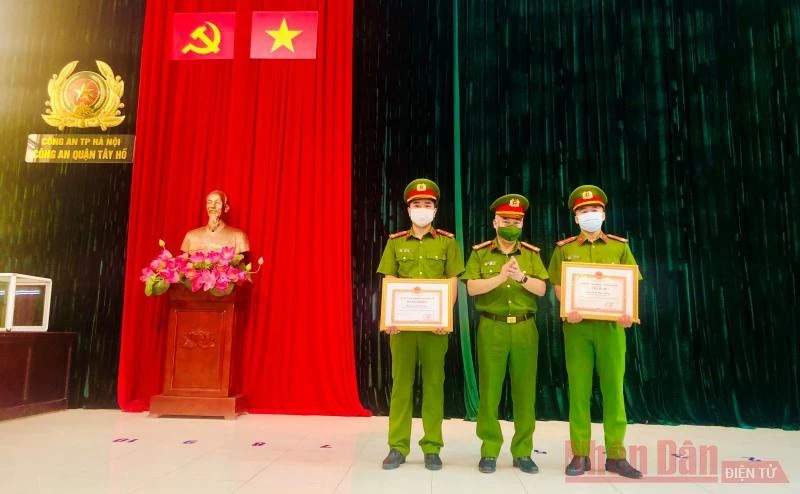 Lãnh đạo Công an quận Tây Hồ trao bằng khen của Chủ tịch UBND TP Hà Nội tặng hai chiến sĩ Công an kịp thời cứu người.