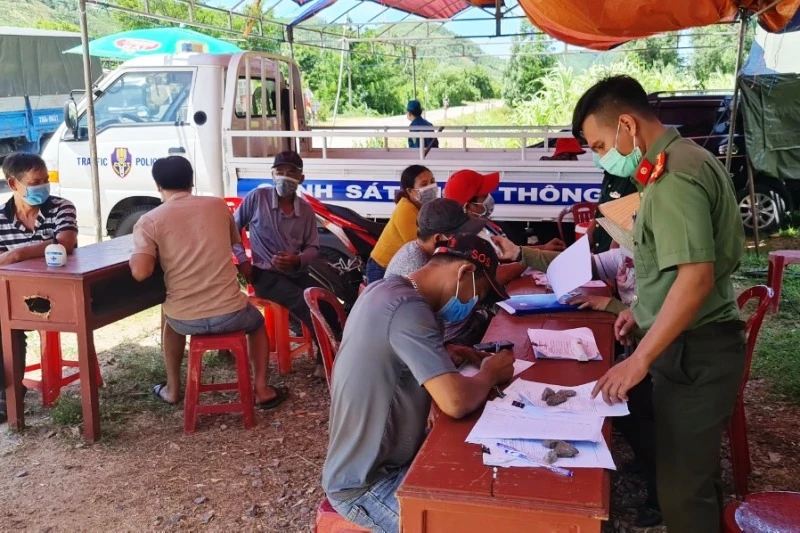 Lực lượng công an hướng dẫn người dân khai báo y tế ở chốt kiểm dịch xã Canh Hòa, huyện Vân Canh, tỉnh Bình Định.