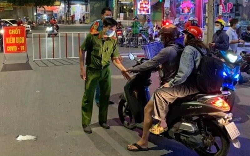 Lực lượng chức năng kiểm tra việc chấp hành Chỉ thị 16 của người dân ở thành phố Biên Hòa trong tối 10/7.
