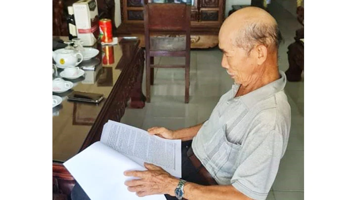 Ông Đặng Thành Biên xem các tài liệu về anh trai.