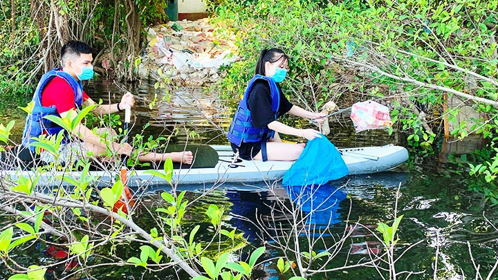 Hoạt động chèo thuyền sup vớt rác trên sông Hương được nhiều bạn trẻ đăng ký tham gia.