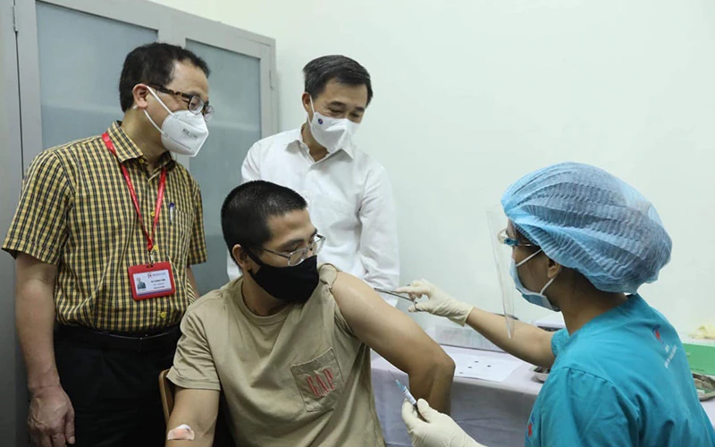 GS, TS Tạ Thành Văn và GS, TS Trần Văn Thuấn chứng kiến mũi tiêm thử nghiệm cho tình nguyện viên đầu tiên. (Ảnh: NGUYỄN QUYẾT)