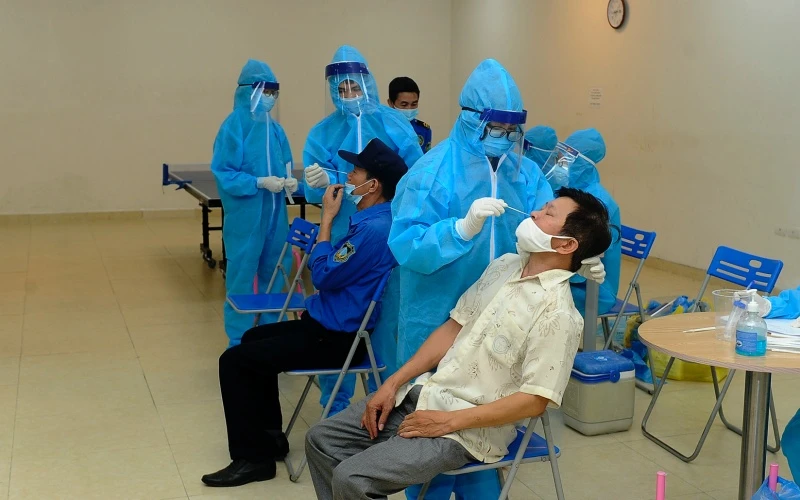 Nhân viên y tế lấy mẫu xét nghiệm Covid-19 cho nhân dân tổ 32, phường Vĩnh Hưng, quận Hoàng Mai (Hà Nội). (Ảnh: Đăng Khoa)