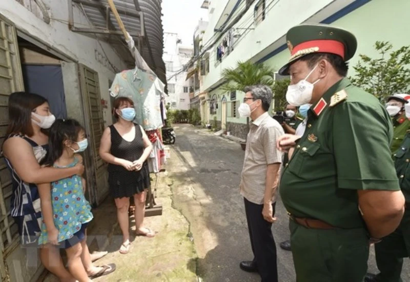 Phó Thủ tướng Vũ Đức Đam thăm hỏi người dân thuê trọ trên địa bàn phường 14, quận Gò Vấp. (Ảnh: TTXVN) 