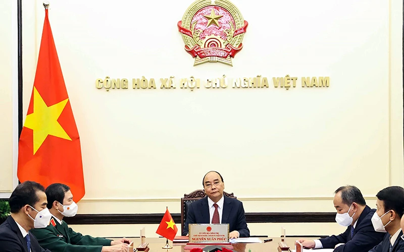 Chủ tịch nước Nguyễn Xuân Phúc tại cuộc điện đàm. Ảnh TTXVN