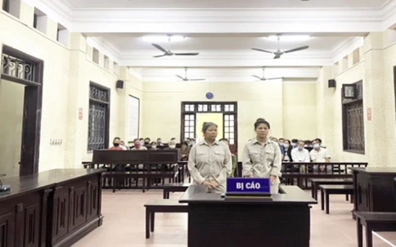 Bị cáo Đặng Thị Chính và Trịnh Thị Huyền tại phiên tòa.