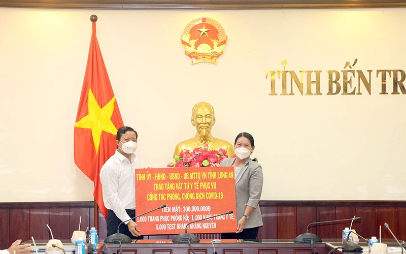 Phó Chủ tịch UBND tỉnh Bến Tre Nguyễn Thị Bé Mười tiếp nhận hỗ trợ từ Phó Chủ tịch UBND tỉnh Long An Phạm Tấn Hòa.