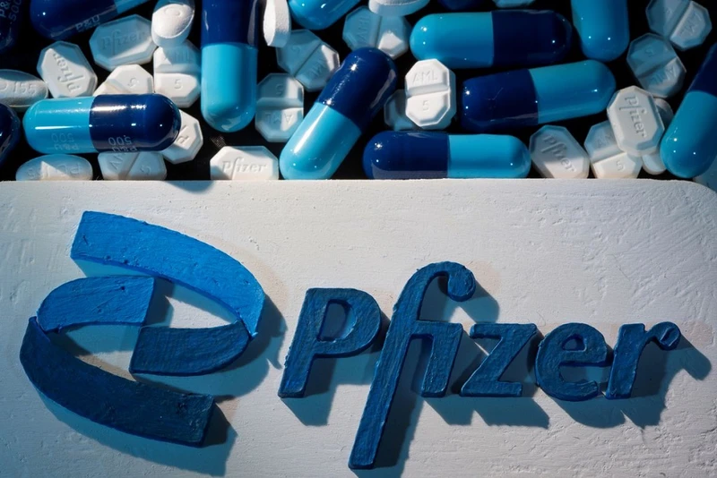 Logo Pfizer được đặt gần các viên thuốc của hãng. Ảnh: Reuters.