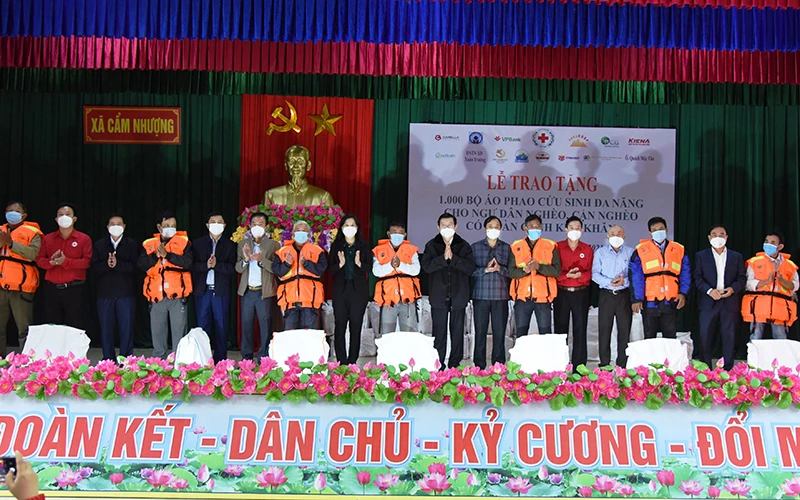 Nguyên Chủ tịch nước Trương Tấn Sang và đại diện lãnh đạo Hội Chữ thập đỏ Việt Nam, tỉnh Hà Tĩnh cùng các nhà tài trợ trao áo phao đa năng cho ngư dân xã Cẩm Nhượng (Cẩm Xuyên). 