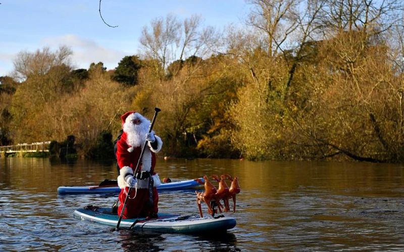Hóa trang thành ông già Noel và dùng ván lướt sóng di chuyển trên sông Liffey, thành phố Dublin, Ireland, để mang đến niềm vui Giáng sinh trong không khí ảm đạm của đại dịch Covid-19.