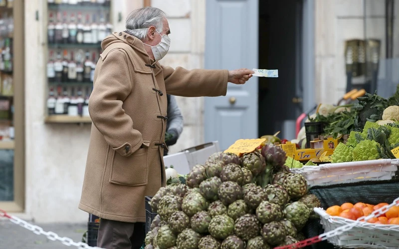 Người dân mua hàng hóa tại một khu chợ ngoài trời ở Rome, Italia, ngày 12/3/2021. (Ảnh: Reuters)