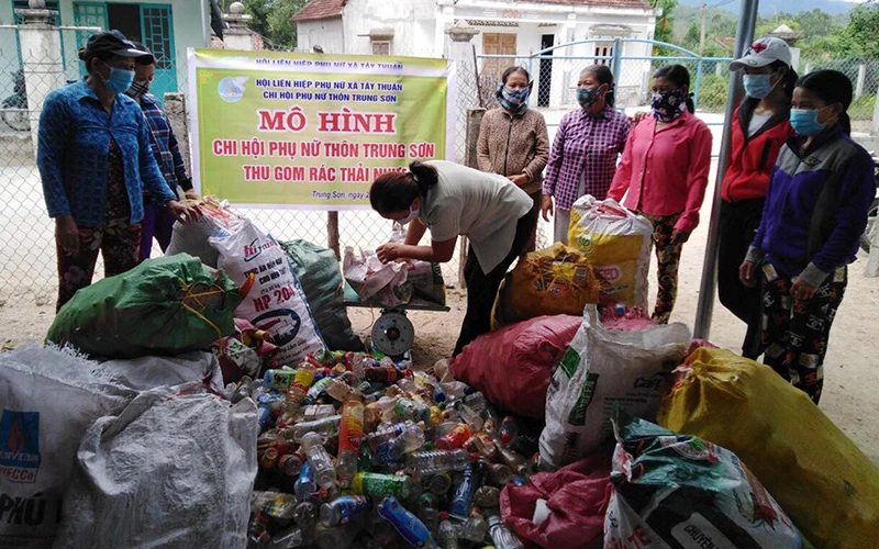 Hội viên phụ nữ xã Tây Thuận, huyện Tây Sơn (Bình Ðịnh) thu gom rác thải nhựa gây quỹ tặng học sinh nghèo. Ảnh: TRÚC LY